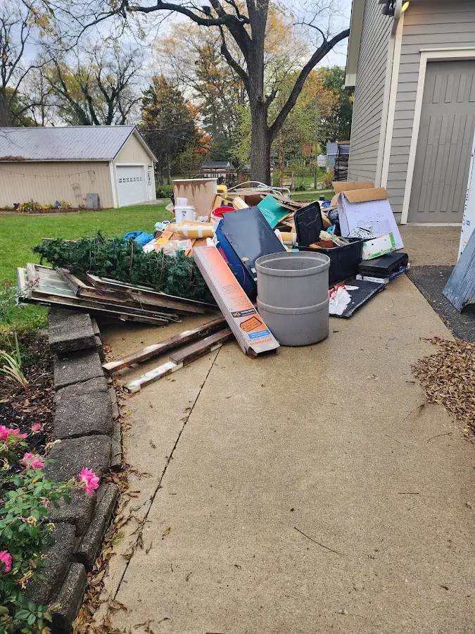 Dumpster being loaded with debris for 12 Yard Dumpster Rental in Minden